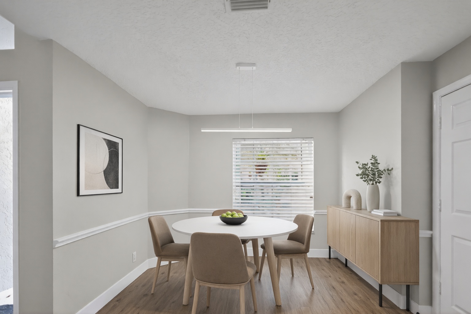 Dining room after AI virtual staging with table seating lighting and decor